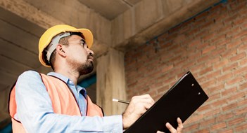 Engineer or inspector checking progressing work in construction site